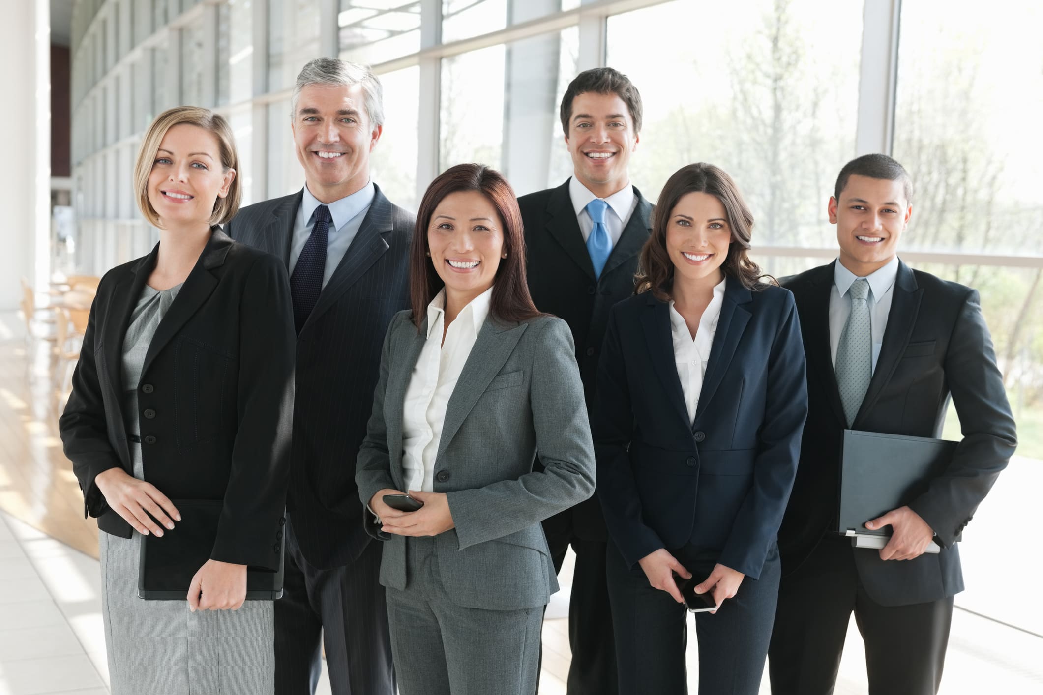 Group portrait of multiethnic business team standing together in office.